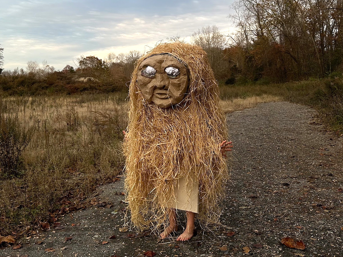 Large puppet with hay in a field